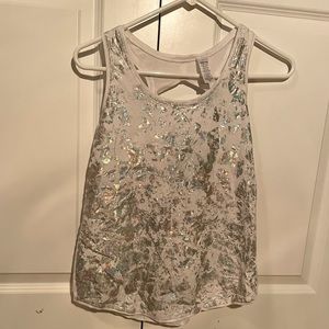 White athletic tank top with silver metallic designs from ivivva by lululemon